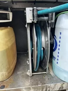 Internal hose reel installed inside Nilfisk SH Truck pressure washer cabinet protecting hose from frost damage.